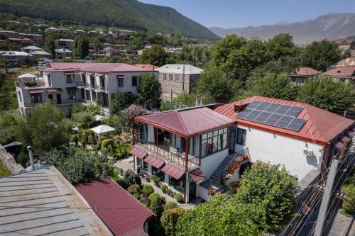 an aerial view of a house with solar panels on the roof at REDROOF country house hotel in Goris