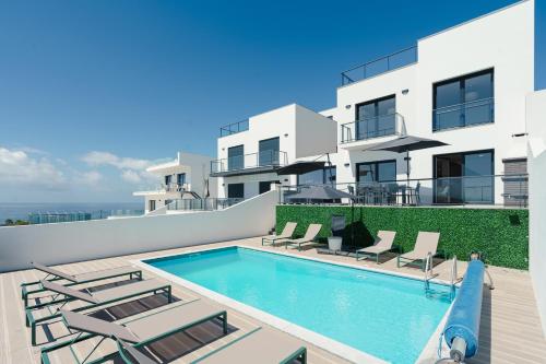 a swimming pool on the roof of a house at Bela Vista with sea view, jacuzzi and private pool in Lourinhã