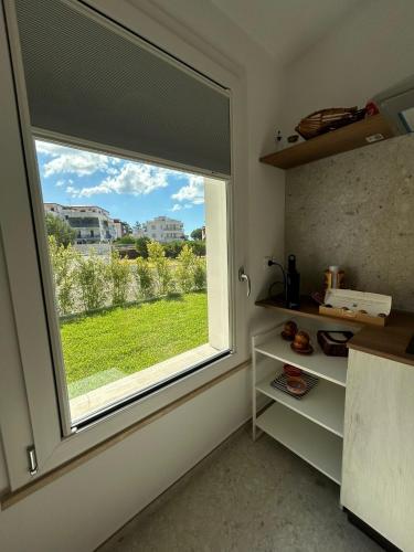 a kitchen with a large window with a view at Villa Gisa in Calalunga-Pietragrande