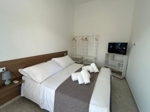 a bedroom with a large white bed with two pillows at Villa Gisa in Calalunga-Pietragrande