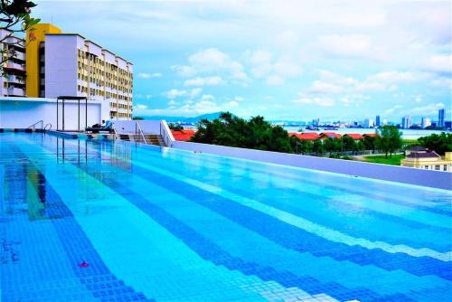 a large swimming pool on top of a building at Spacious Comfy 8pax, 3 Bedroom, 2 Car Park, The Landmark in Tanjong Tokong