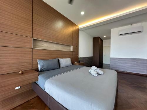 a bedroom with a large bed with two towels on it at Spacious Comfy 8pax, 3 Bedroom, 2 Car Park, The Landmark in Tanjong Tokong
