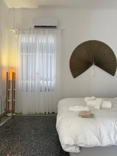 a bedroom with a bed with an umbrella on it at Sea Breeze Boutique in Karistos