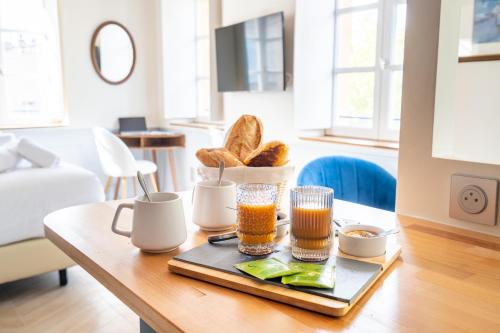 a table with a tray of bread and drinks on it at La Réserve de Salon de Provence in Salon-de-Provence