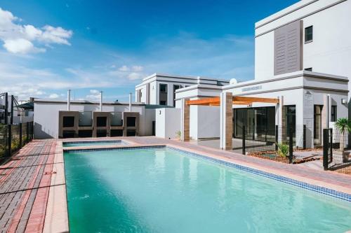 a swimming pool in front of a house at Lanekwa's in Gaborone
