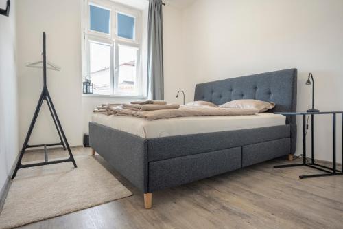 a bedroom with a bed in a white room at Apartmán Palackého in Tábor