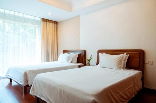 Katil atau katil-katil dalam bilik di Golden Peach Riverside Manor