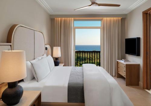 a bedroom with a bed with a view of the ocean at The Westin Resort, Costa Navarino in Romanós