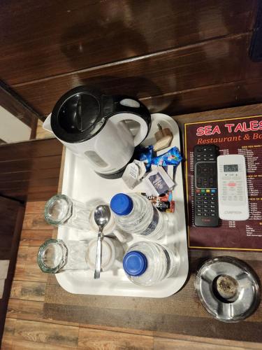 a table with a tea kettle and other items on it at Comfort Home in Bhopal