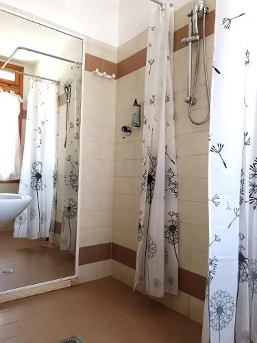a bathroom with a shower curtain and a sink at Hotel Nazionale in Lido di Jesolo