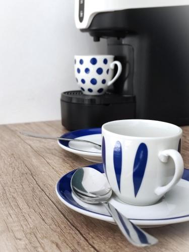 a coffee cup and saucer on a table with a coffee maker at LianHome b&b "Volte" in Lucera