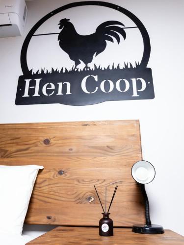 a sign for a hen coop hanging on a wall at Farmco Marloth Park in Marloth Park