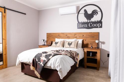 a bedroom with a bed and a sign that reads hen coop at Farmco Marloth Park in Marloth Park