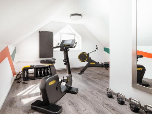 a gym with exercise equipment in a attic at ibis Styles Neckarsulm in Neckarsulm