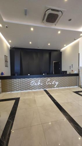 a large room with a stage and a black screen at Panorama King Suite Sea View Hotel in Batumi