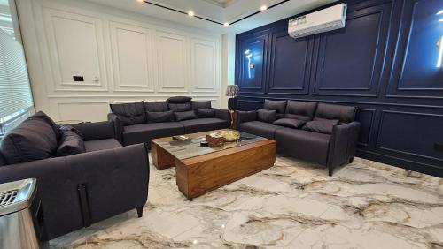 a living room with couches and a coffee table at Skyline Hotel in Sargodha