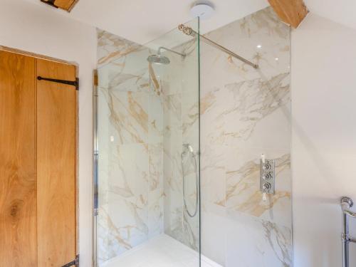 a bathroom with a shower with a glass door at 1 Bed in Montacute 93149 in Montacute