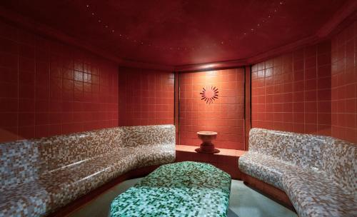 a room with three chairs and a couch in it at Lotus Therme Hotel & Spa in Hévíz