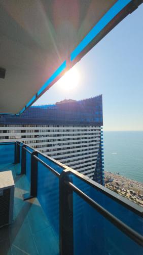 a balcony of a building with a view of the ocean at Panorama King Suite Sea View Hotel in Batumi