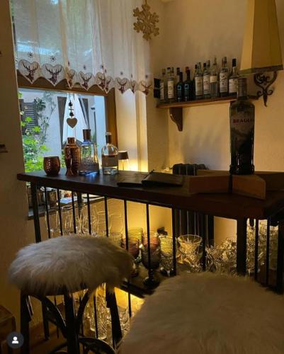 a room with a table with bottles and a stool at Albergo Aprica Garni in Aprica