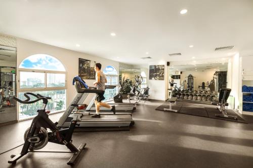 a woman running on a treadmill in a gym at T-Ritz Saigon Hotel & Apartment in Ho Chi Minh City
