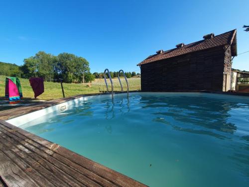 a swimming pool with two pairs of skis in it at Ferme de la felicità in Montbarla