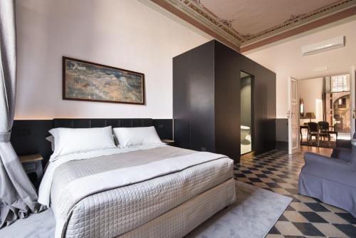 a bedroom with a bed with a painting on the wall at La Terrazza Sul Campo-Rooms Only in Siena