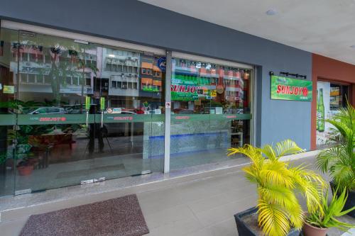 a store front with glass windows and plants at Hotel Sunjoy9 OKR in Kuala Lumpur