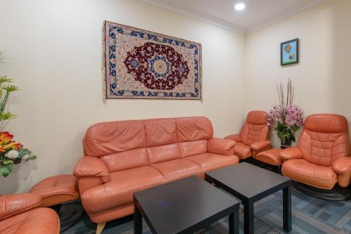 a living room with a couch and two chairs at Hotel Sunjoy9 OKR in Kuala Lumpur