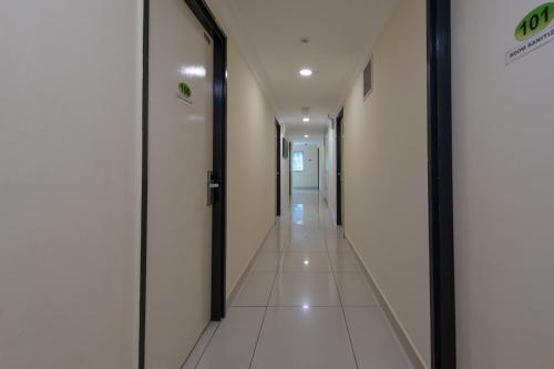 a corridor of a hospital hallway with doors at Hotel Sunjoy9 OKR in Kuala Lumpur