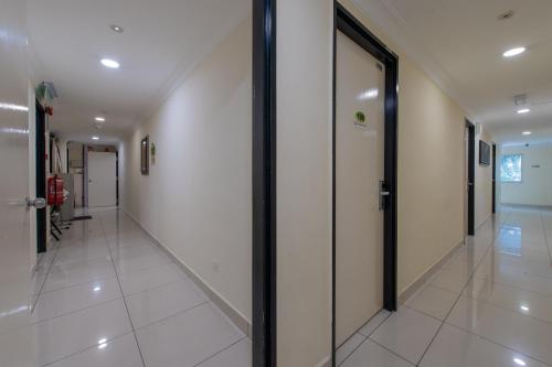 a hallway of a building with glass doors at Hotel Sunjoy9 OKR in Kuala Lumpur