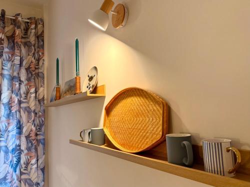a room with a shelf with a basket and mugs at Twin Homes - Tamerò Estates in Poggio Mirteto