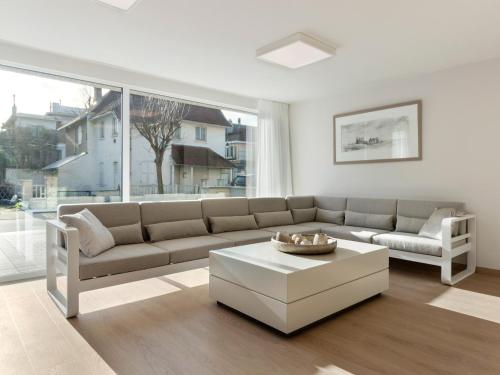 a living room with a couch and a coffee table at Beachfront Home with Sauna in De Panne