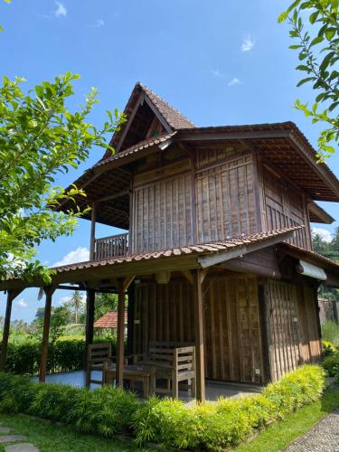 an asian style house with a wooden roof at Kubu Sakian Villa and Restaurant Sidemen in Silebeng