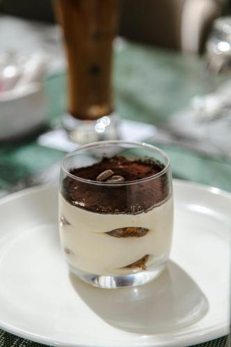 a glass of coffee on a plate on a table at NearYo Hotels in Marrakech