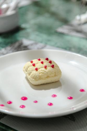a cookie on a white plate with red sprinkles at NearYo Hotels in Marrakech