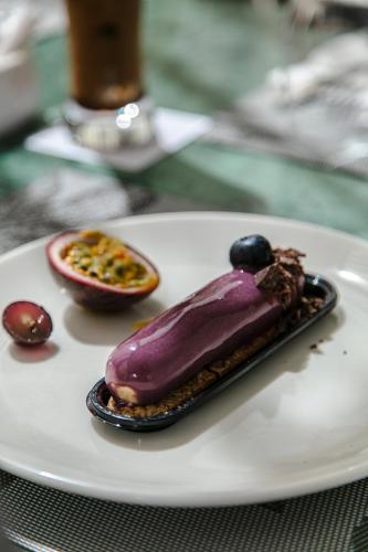 a purple dessert on a white plate on a table at NearYo Hotels in Marrakech