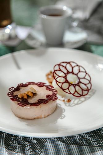 a plate with two donuts and a cup of coffee at NearYo Hotels in Marrakech