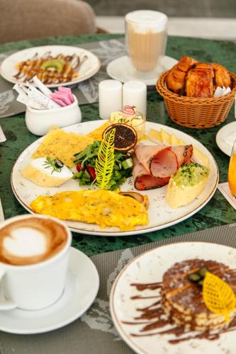 a table with plates of food and a cup of coffee at NearYo Hotels in Marrakech