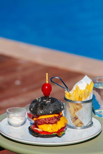 a plate with a hamburger and chips on a table at NearYo Hotels in Marrakech
