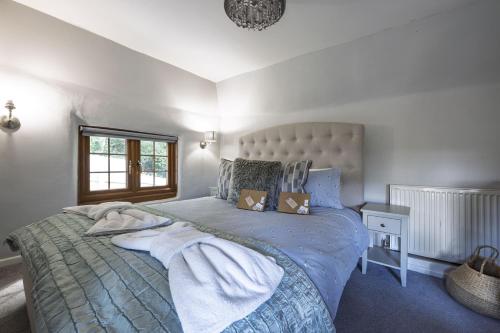 a bedroom with a large bed and a window at Ashdale Cottage in Christchurch