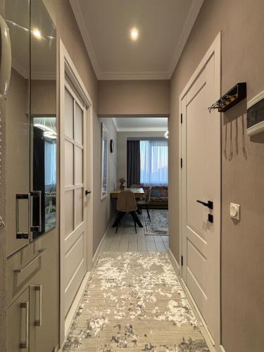 a hallway with a door and a table in a room at Small but cute flat in Durleşti