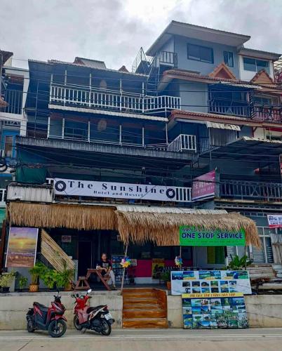 two motorcycles parked in front of a building at The Sunshine hostel and hotel in Ko Lanta