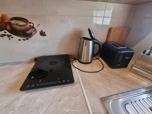 a laptop sitting on a counter next to a coffee maker at Chata Kemp in Tatranska Strba