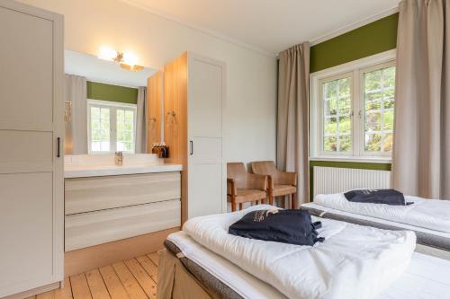 a hotel room with two beds and a sink at Åre Travel - Villa Årebo in Åre