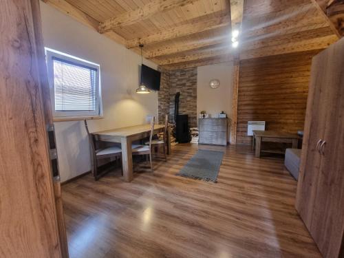 a living room with a table and a dining room at Chata Kemp in Tatranska Strba