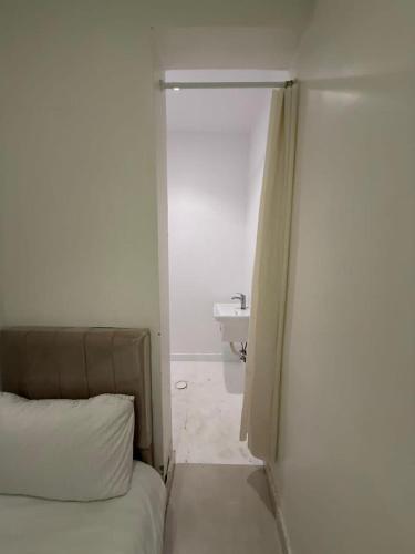 a bedroom with a bed and a bathroom with a sink at Room in Aread in Riyadh