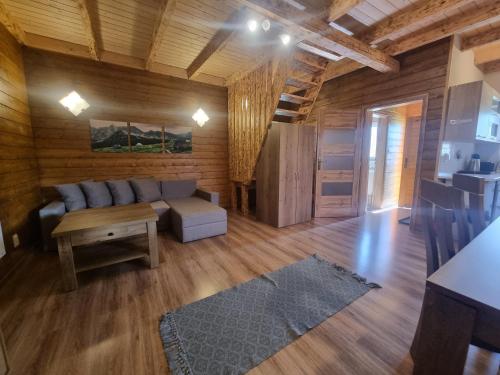a living room with a couch and a table at Chata Kemp in Tatranska Strba