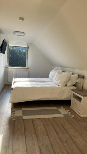 a bedroom with a large bed and a window at Heaven's Door in Magdalensberg