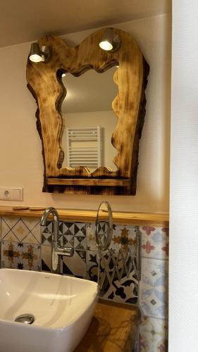 a bathroom with a sink and a mirror on the wall at Heaven's Door in Magdalensberg